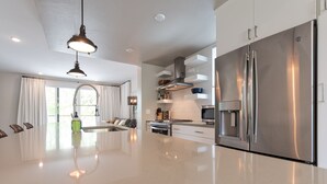 A modern kitchen with a large island, stainless steel appliances, and a bright, open layout. - 
Townhome with Stunning Views & Modern Finishes (Missoula)