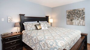 A bedroom with a bed, nightstands, a lamp, a ceiling fan, and a wall art piece. - Family Home in Town, Across from Rio Grande Trail (Glenwood Springs)