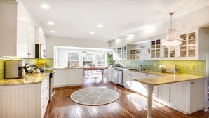 A spacious kitchen with white cabinetry, a wooden floor, and a central island. - Location!!! Location!!! Berkshire Glamour (and comfort) Meets Town And Country (Stockbridge)