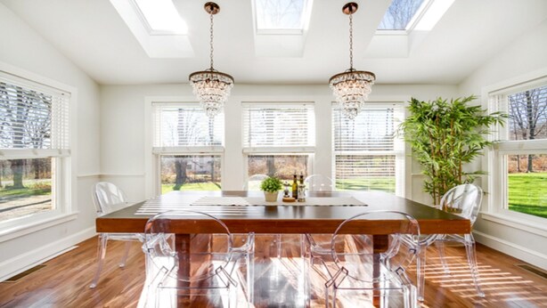 A dining area with a wooden table and clear chairs, large windows with blinds, and a chandelier. - Location!!! Location!!! Berkshire Glamour (and comfort) Meets Town And Country (Stockbridge)