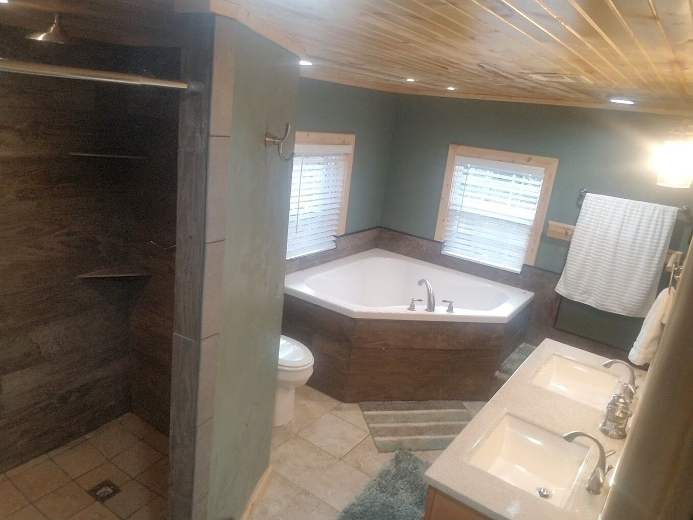 Bathtub, hair dryer, towels, toilet paper