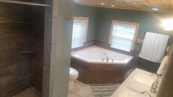 Bathtub, hair dryer, towels, toilet paper
