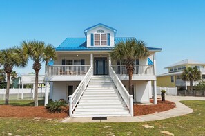 Stunning two-story residence with a charming front entrance, complete with a staircase and white picket fence.