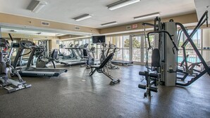 A gym with treadmills, elliptical machines, and weight equipment.