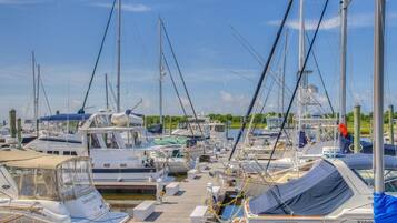A marina with multiple boats docked at wooden piers.