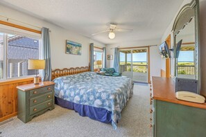 A bedroom with a bed, dresser, and a view of the ocean. - Oceanfront Home in Avon with Hot Tub, Game Room, and Direct Beach Access (Avon)