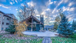 A modern building with a prominent tower, surrounded by trees and a paved area with benches. - Cozy condo in Steamboat Springs.  Close to slopes! (Steamboat Springs)