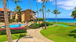 A resort with a pool, palm trees, and a view of the ocean. - Best Papakea Location - Incredible Ocean View - Fully Renovated (Lahaina)