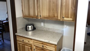 A kitchen with wooden cabinets, a marble countertop, and a toaster. - Breathtaking Views, Huge Deck, Private, Fireplace, 4 Bedroom 2 Bath, Sleeps 10

 (Estes Park)