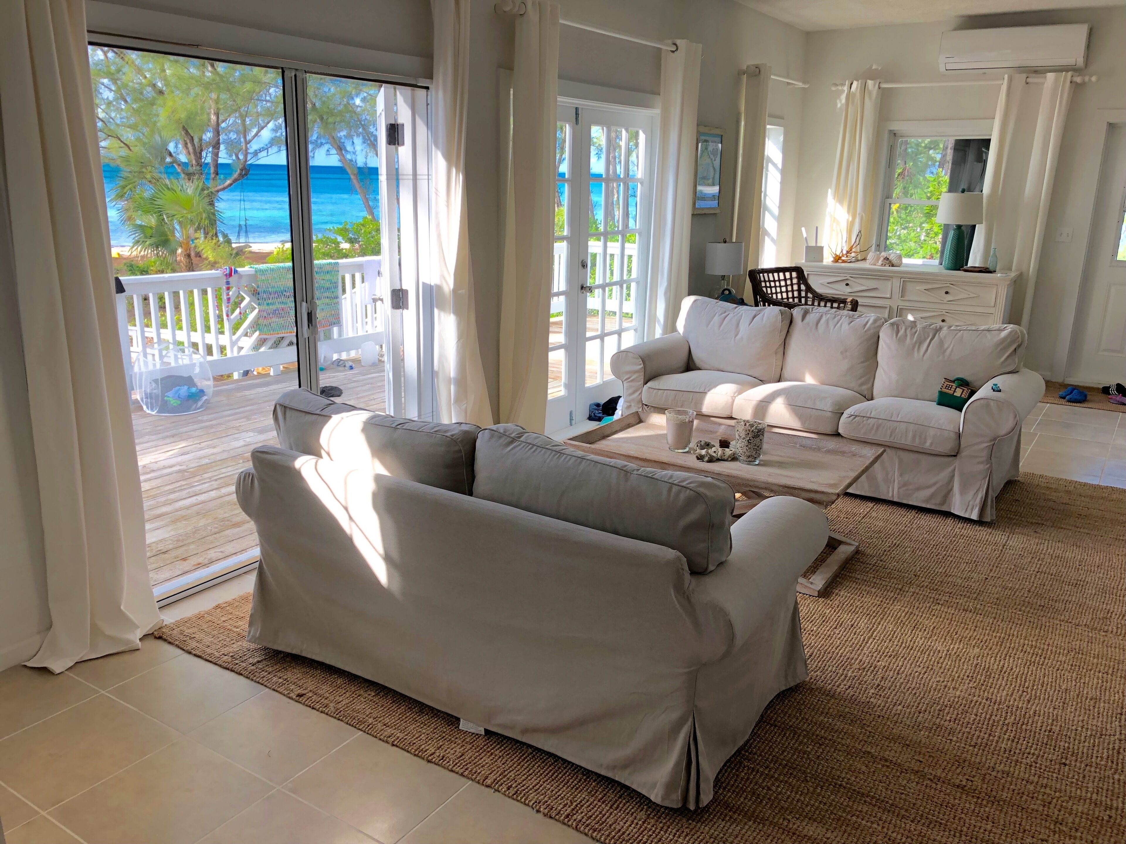 Living room opens out onto expansive sea facing deck