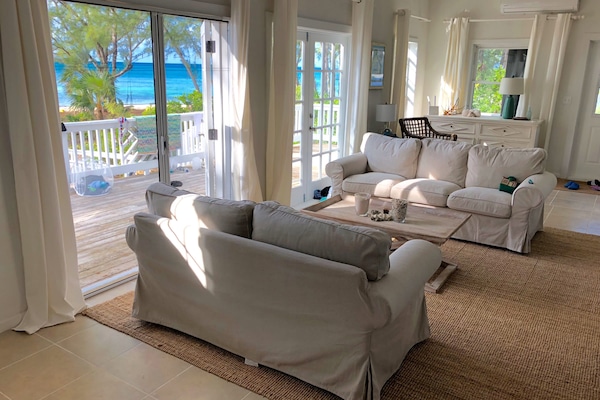 Living room opens out onto expansive sea facing deck