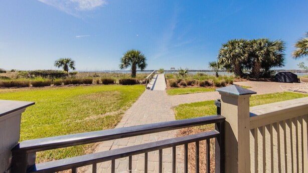 A paved pathway leading to a beach with palm trees and a clear sky. - Immaculate, 193 5-Star Reviews, Amazing Views, Updated, Pool heated/cooled (Hilton Head Island)