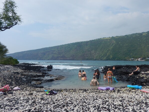 A beach with rocky terrain and a view of the ocean.