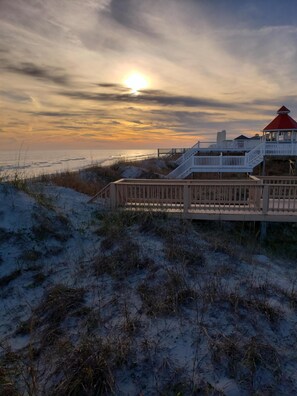 A beach house with a wooden deck and a red roof, overlooking the ocean. - Rare partial summer week availability: June 1-6;  July 26-July 30th!!  Book now. (Ocean Isle Beach)