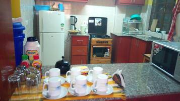 Shared fridge, microwave, electric kettle, cookware/dishes/utensils