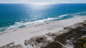 A beach with a clear view of the ocean and a sandy shoreline. - FloraBama Inspired Waterfront Condo w/ Boat Slip next To The Famous Florabama  (Pensacola)