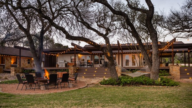 A patio area with outdoor seating, a fire pit, and string lights. - Rio de Arcadia - Two Riverside Homes, Pool & Hot Tub (Kerrville)