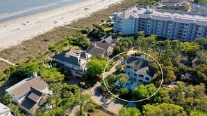 A coastal hotel with multiple buildings, a beach in the background, and a pool surrounded by lush greenery. - Stunning Ocean View Vacation House with Private Pool, 1 Min From Beach! (Hilton Head Island)