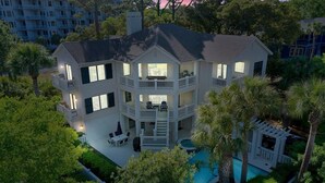 A multi-story house with a pool, surrounded by trees and a fence. - Stunning Ocean View Vacation House with Private Pool, 1 Min From Beach! (Hilton Head Island)