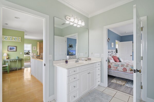 A bathroom with a large mirror, white vanity, and a sink. - "Endless Views" - 2nd Row Home w/ Private Pool, 4 Bedrooms / 3 Bathrooms (Holden Beach)