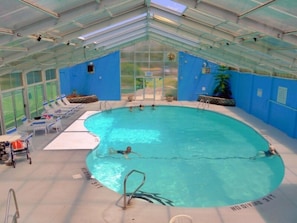 Enjoy a relaxing swim in our indoor pool surrounded by lounge chairs and a pool table.