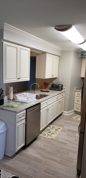 Enjoy cooking in this well-equipped kitchen with an oven, sink, and dishwasher.