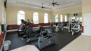 A gym with treadmills, elliptical machines, and weight equipment.