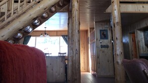 A wooden interior with a staircase, a ceiling fan, and a sign reading "A TREE FRIEND."