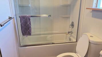 Bathtub, hair dryer, towels, soap