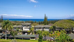 A coastal resort with multiple-story buildings, a parking area, and a view of the ocean. - KGV 24T8  Spacious 1BD Oceanview Villa (Lahaina)