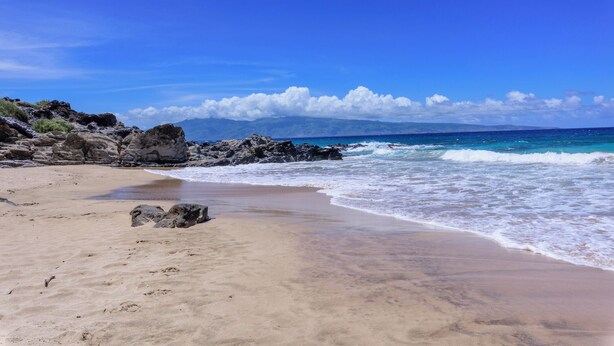 A beach with clear skies, rocky shoreline, and waves. - KGV 24T8  Spacious 1BD Oceanview Villa (Lahaina)