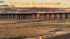 A beach scene with a pier extending into the water. - 153 Grand Island Blvd ~ Total Reno~Custom Kitchen~Granite~WiFi (Panama City Beach)