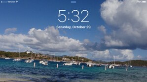 A beach with boats and a clear sky.