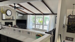 A spacious kitchen with a large island, a fireplace, and a dining area with a view of the outdoors. - 4 Bed and 3 Bath  - Lakefront with private dock (Camdenton)