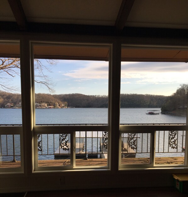 Enjoy breathtaking views of the water from the comfort of your room, with a dock and forested shoreline visible from the large windows.
