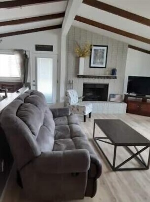 Relax in this stylish living room with a plush sofa, coffee table, and fireplace.