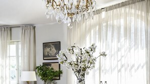 A dining area with a chandelier, dining table, chairs, and a floral centerpiece. - Luxury Village House In The Heart Of Historic St.Remy-De-Provence (Saint-Rémy-De-Provence)