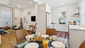 A modern apartment with a dining area, kitchen, and living room. - A2 at Saint Philip Square, One Block to King, Stylish Southern Escape (Charleston)
