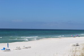 Relax on the beach with comfortable lounge chairs and umbrellas.