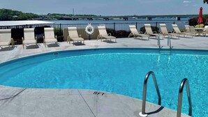 A pool area with lounge chairs and a lifebuoy.