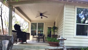 A covered porch with a ceiling fan, outdoor seating, a barbecue grill, and potted plants. - The Place to Relax in San Antonio, only 10 min away from Six Flags Fiesta Texas! (San Antonio)