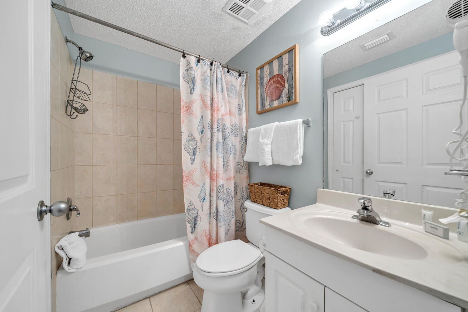 A bathroom with a bathtub, toilet, sink, and shower.