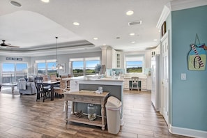 Enjoy a spacious interior with a large dining area, kitchen, and living space, perfect for relaxation and socializing.