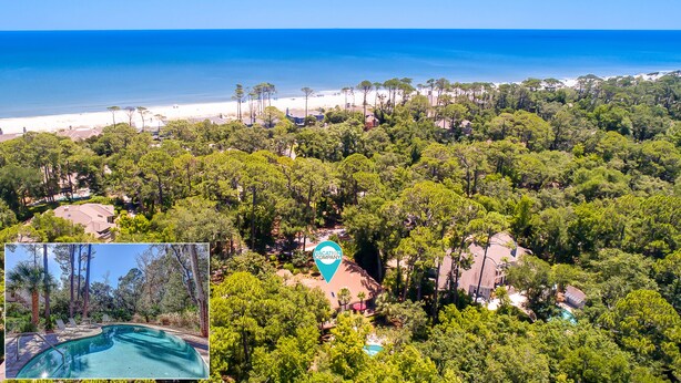 Una propiedad costera con abundante vegetación, piscina y vista al mar.