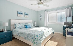 A bedroom with a bed, two bedside tables, a ceiling fan, and a window with curtains. - Amazing Panoramic Views of OC From This Beautiful 2BR 2BA Oceanfront Unit! (Ocean City)