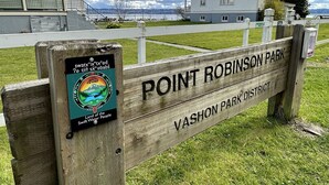 A wooden sign for Point Robinson Park District with a logo and text. - Point Robinson Lighthouse - Keeper's Quarters B (Vashon Island)