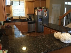 A kitchen with granite countertops, stainless steel appliances, wooden cabinets, and a window with blinds. - Secluded Seneca/Clemson Lake Hartwell Waterfront, 3 miles to CU (Seneca)