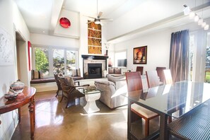 Cozy living space with a large dining table, comfortable seating, and a fireplace.