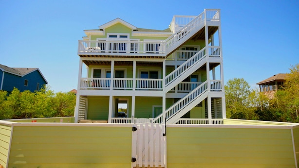 A multi-story building with balconies and a staircase.