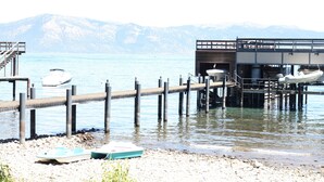 A pier extending into a lake with boats docked at the end. - Cozy Private Lakefront Cottage Surrounded By Lush Trees (Carnelian Bay)